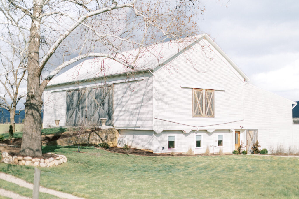Sky Ridge Farm Wedding is a white barn in a field in Waynesboro, VA.