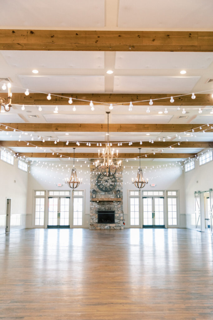 The reception area at King Family Vineyards Wedding  in Crozet is spacious and filled with windows and a tall ceiling.