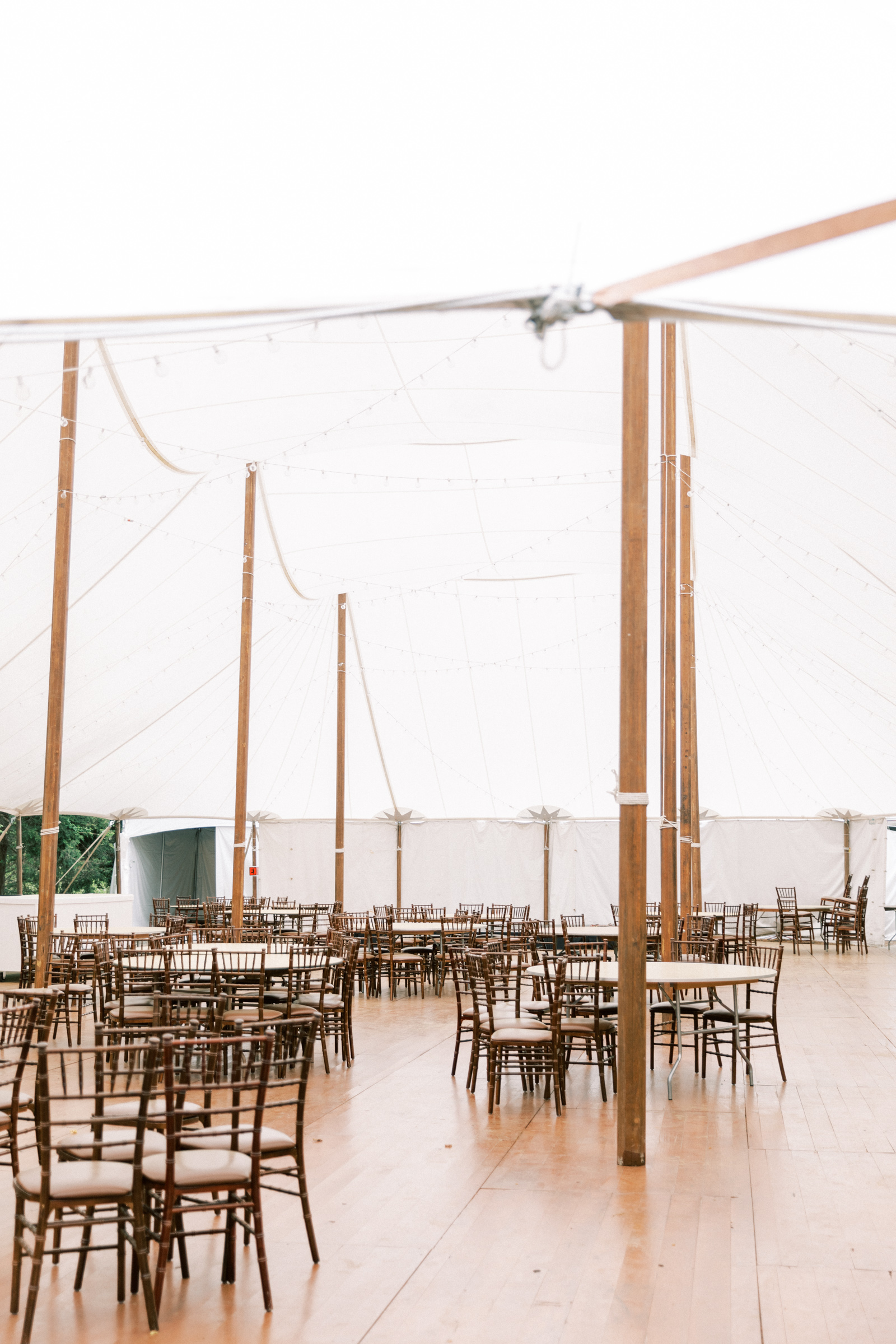 Tented reception space with a hardwood dance floor