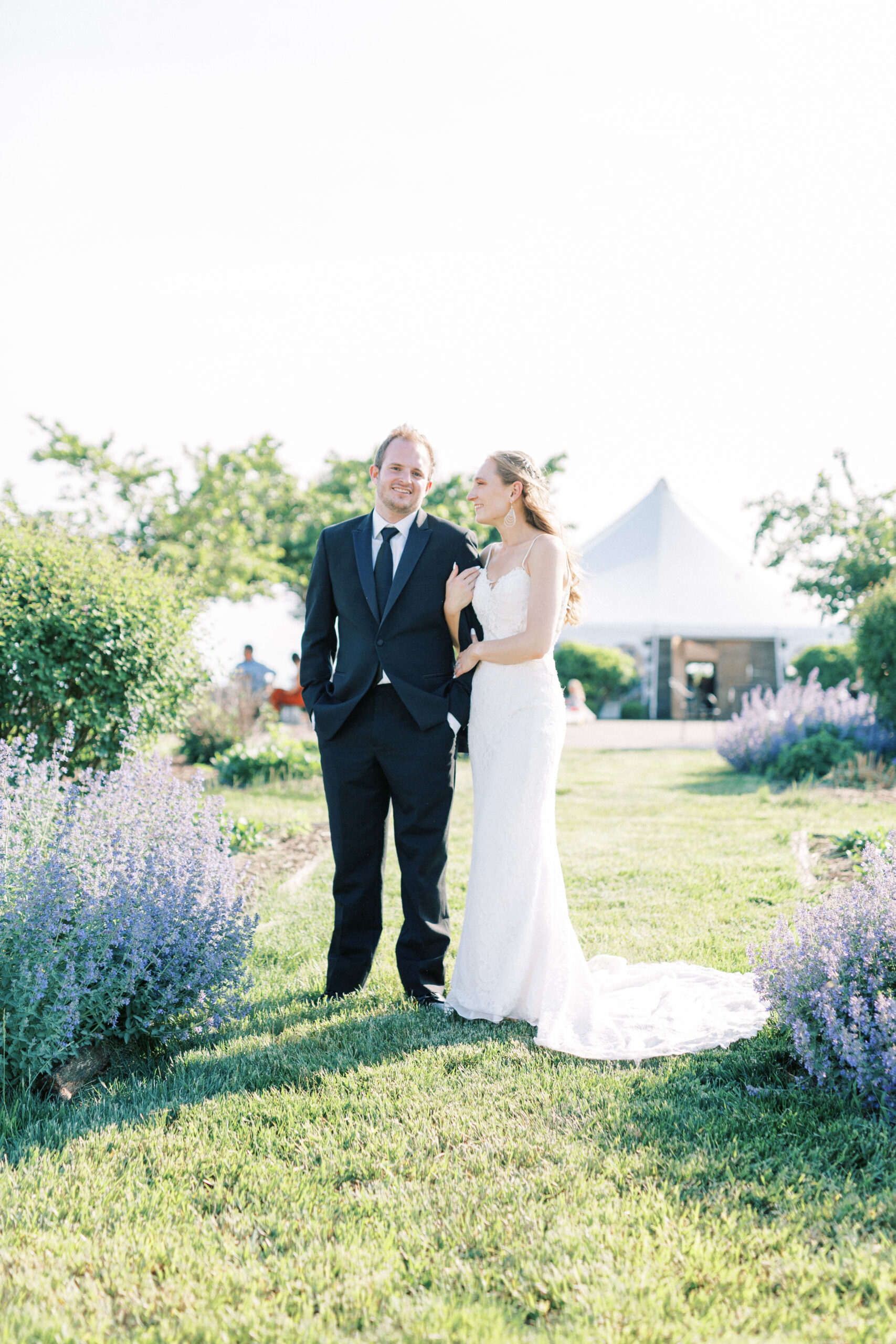 Sunny Slope Farm wedding couple hold hands during portraits right after they get married