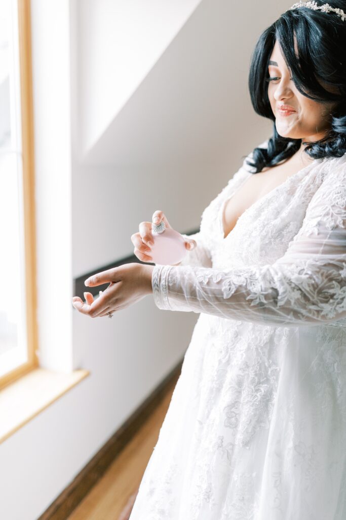 Bride sprays her perfume on before walking down the aisle